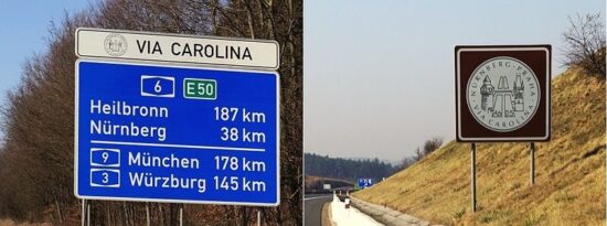 Cedule Via Carolina lemující dálnice D5 a A6